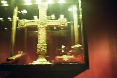 A gem-encrusted gold cross in a lit cabinet — Vienna, Austria (12-16 June 2000)