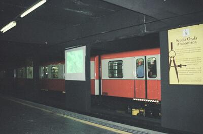 A red metro train at an underground station platform — Milan, Italy (12-16 June 2000)
