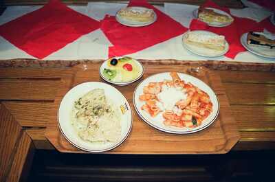 A tray of pasta and dessert on a wooden table — Milan, Italy (12-16 June 2000)