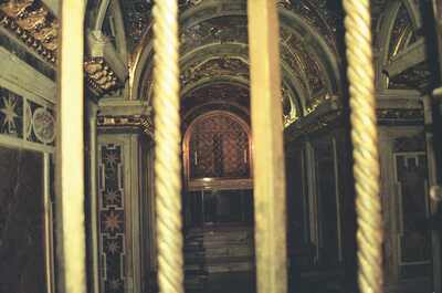 A gilded side chapel seen between twisted columns — St Peter's Basilica, Vatican City (21-27 May 2000)