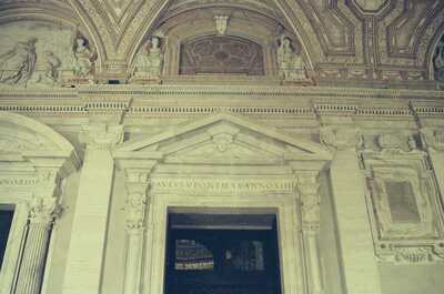 Ornate carved stonework above a portico doorway — St Peter's Basilica, Vatican City (21-27 May 2000)