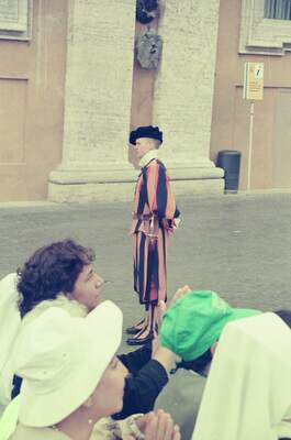 A Swiss Guard in striped uniform watched by tourists — St Peter's Basilica, Vatican City (21-27 May 2000)