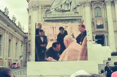 A bishop and crowd shown on the big square screen — St Peter's Basilica, Vatican City (21-27 May 2000)