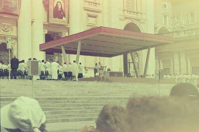 The papal altar canopy with clergy during Mass — St Peter's Basilica, Vatican City (21-27 May 2000)
