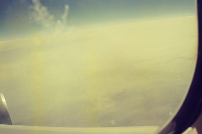 A hazy cloud bank beside the plane wing — In transit, in transit (20-25 May 2000)