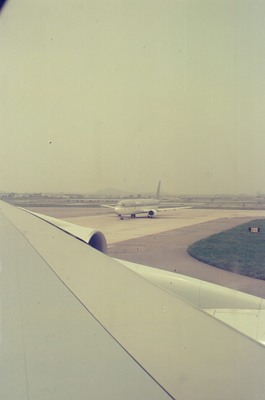 A jet taxiing past trees on the airport apron — Seoul, in transit (20-25 May 2000)