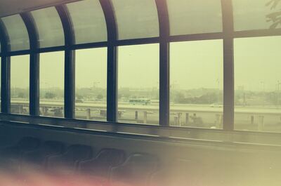 An airport bus seen through curved terminal windows — Seoul, in transit (20-25 May 2000)