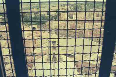 Rooftops of Rome seen through a dome window grille — St Peter's Basilica, Vatican City (21-27 May 2000)