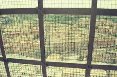 Apartment blocks viewed through St Peter's dome grille — St Peter's Basilica, Vatican City (21-27 May 2000)
