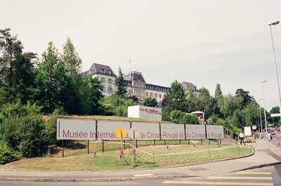 The Red Cross Museum building above a banner sign — Geneva, Switzerland (1-3 July 2000)