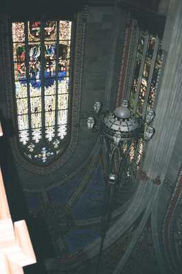 A chandelier below stained glass in St-Pierre Cathedral — Geneva, Switzerland (1-3 July 2000)
