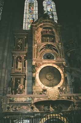The Strasbourg astronomical clock beside stained glass — Strasbourg, France (1-3 July 2000)