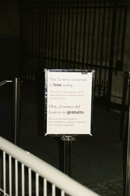 A sign announcing free admission to the Louvre — Paris, France (1 July 2000)