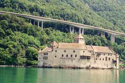 Chateau de Chillon below a curving highway viaduct — Montreux, Switzerland (1 July 2000)