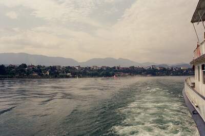 A lakeside town seen from the stern of a boat — Geneva, Switzerland (1 July 2000)