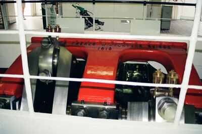 The red steam engine of a Lake Geneva paddle steamer — Geneva, Switzerland (1 July 2000)