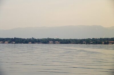 A small plane landing low over the lakeshore — Geneva, Switzerland (1 July 2000)