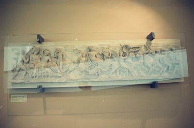 A carved Roman sarcophagus relief behind glass — Vatican Museums, Vatican City (21-27 May 2000)