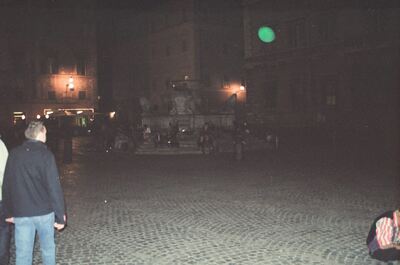 A dim fountain and crowd in a night piazza — Rome, Italy (21-27 May 2000)