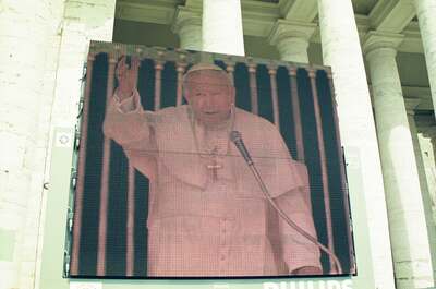 A giant screen showing the Pope at a microphone — St Peter's Basilica, Vatican City (21-27 May 2000)