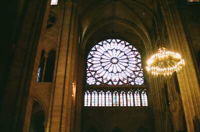 The glowing rose window and chandelier inside Notre-Dame — Paris, France (22-28 June 2000)
