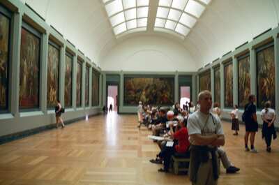 A framed painting of a saint hung on a green wall — Paris, France (22-28 June 2000)
