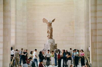 The Winged Victory above a crowd of museum visitors — Paris, France (22-28 June 2000)
