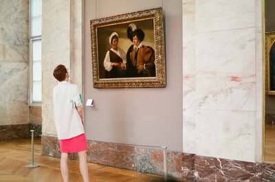 A woman viewing a Caravaggio painting in a marble hall — Paris, France (22-28 June 2000)