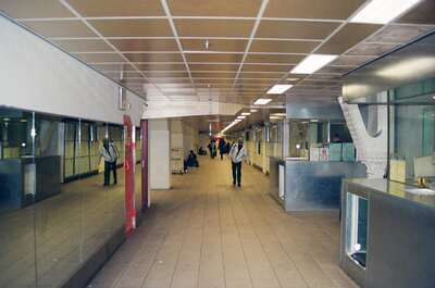 A long covered walkway lined with shop windows — Netherlands, The Netherlands (19-26 June 2000)