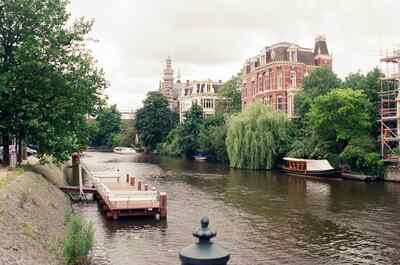 A tranquil canal lined with trees and grand houses — Amsterdam, The Netherlands (19-26 June 2000)