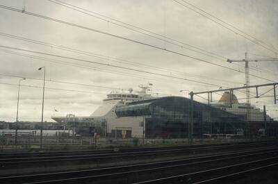 A docked cruise ferry beyond railway lines and wires — Netherlands, The Netherlands (19-26 June 2000)