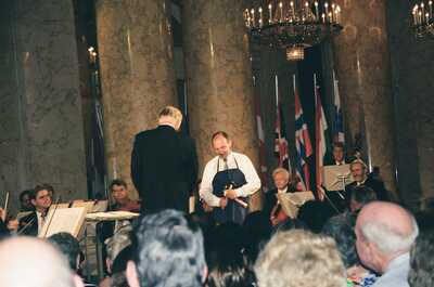 Richard receiving an award beside a tuxedoed presenter on stage — Vienna, Austria (14-16 June 2000)