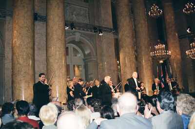 A violinist bows as the orchestra performs in the grand hall — Vienna, Austria (14-16 June 2000)