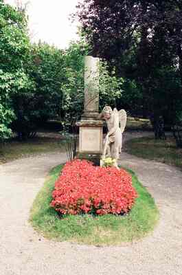 A garden statue monument above a bed of red flowers — Vienna, Austria (14-16 June 2000)
