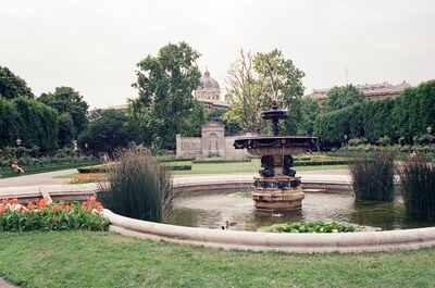 A tiered fountain in the Burggarten with a domed museum beyond — Vienna, Austria (14-16 June 2000)