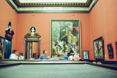 Visitors before a towering altarpiece in a grand gallery room — Vienna, Austria (16-18 June 2000)