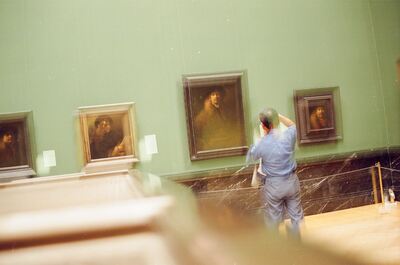 A man photographing Rembrandt portraits in a green gallery — Vienna, Austria (16-18 June 2000)