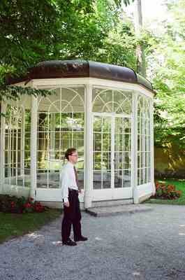 Richard leaning against an ornate garden glasshouse — Salzburg, Austria (16-18 June 2000)