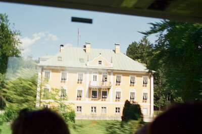 A yellow baroque manor house seen from the bus window — Salzkammergut, Austria (16-18 June 2000)
