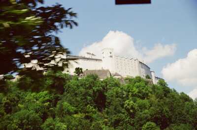 Hohensalzburg Fortress crowning its forested hilltop — Salzburg, Austria (16-18 June 2000)