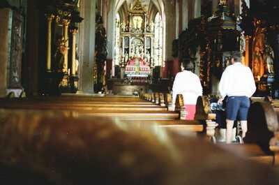Visitors walk toward the gilded altar inside the church — Salzkammergut, Austria (16-18 June 2000)