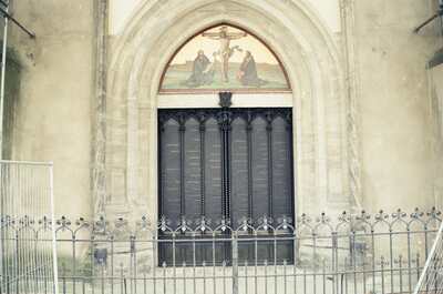 The bronze Theses Door of the Schlosskirche behind a railing — Wittenberg, Germany (22 June 2000)