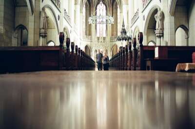 The Gothic nave of the Schlosskirche with two visitors — Wittenberg, Germany (22 June 2000)