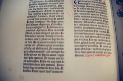 A Gutenberg Bible page with faded coloured initials — Wittenberg, Germany (22 June 2000)