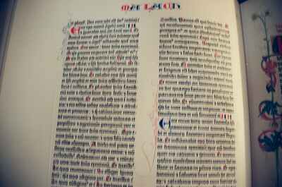 A two-column Gutenberg Bible spread with floral marginalia — Wittenberg, Germany (22 June 2000)