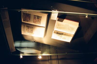 Illustrated old books displayed under angled glass — Wittenberg, Germany (22 June 2000)