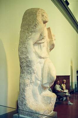 Unfinished marble sculpture in a museum glass case — Florence, Italy (late May 2000)