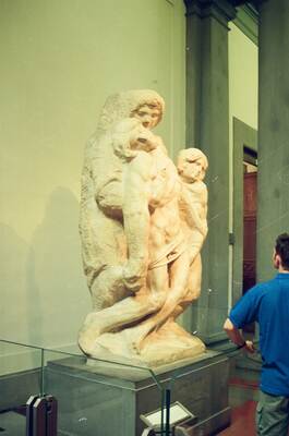 Richard leaning over Michelangelo's unfinished Slaves — Florence, Italy (late May 2000)
