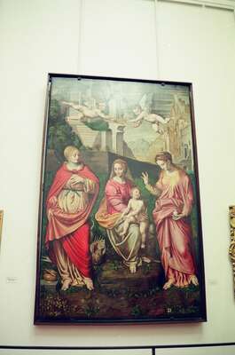 Renaissance holy family painting on a white wall — Florence, Italy (26 May 2000)