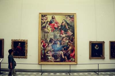 Woman walking past a large altarpiece in the Uffizi — Florence, Italy (26 May 2000)